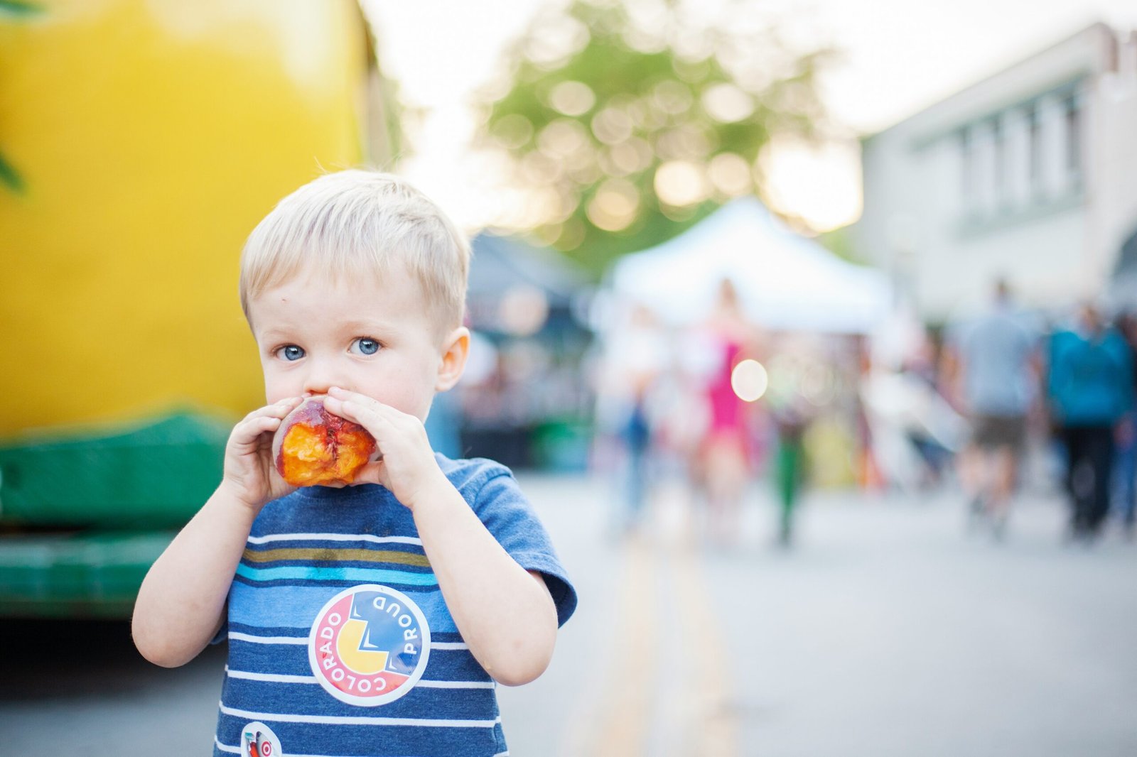 a little boy eating a piece of food